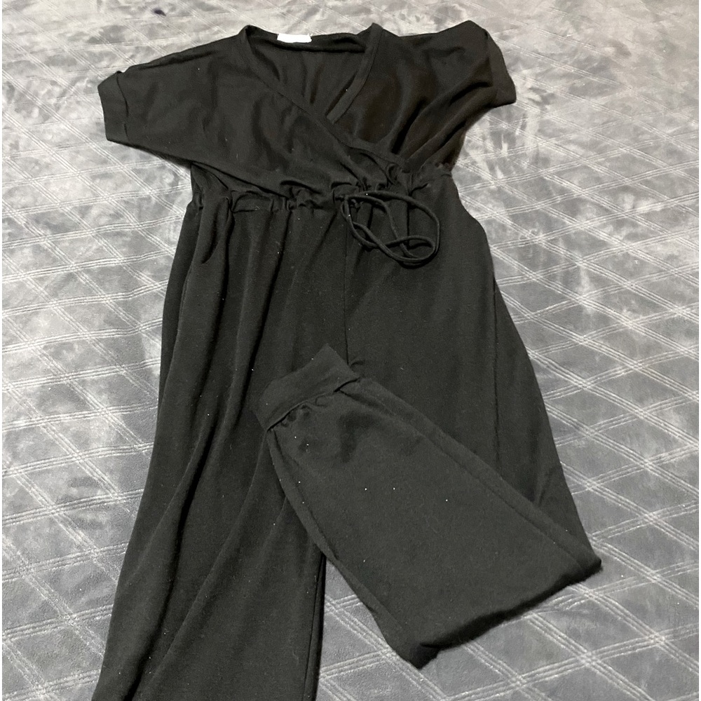 Black Jumpsuit short sleeve surplice top elastic drawstring waist.